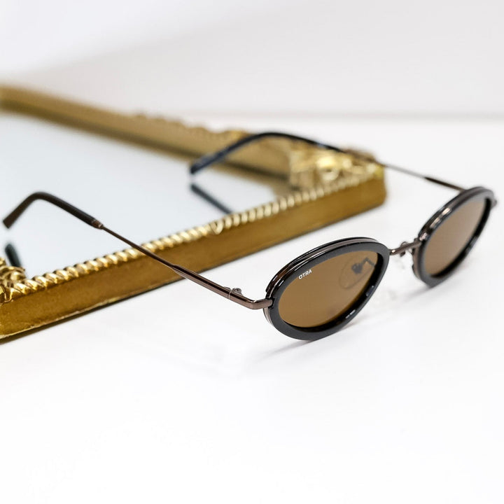 Sunglasses with a gold frame on a white background