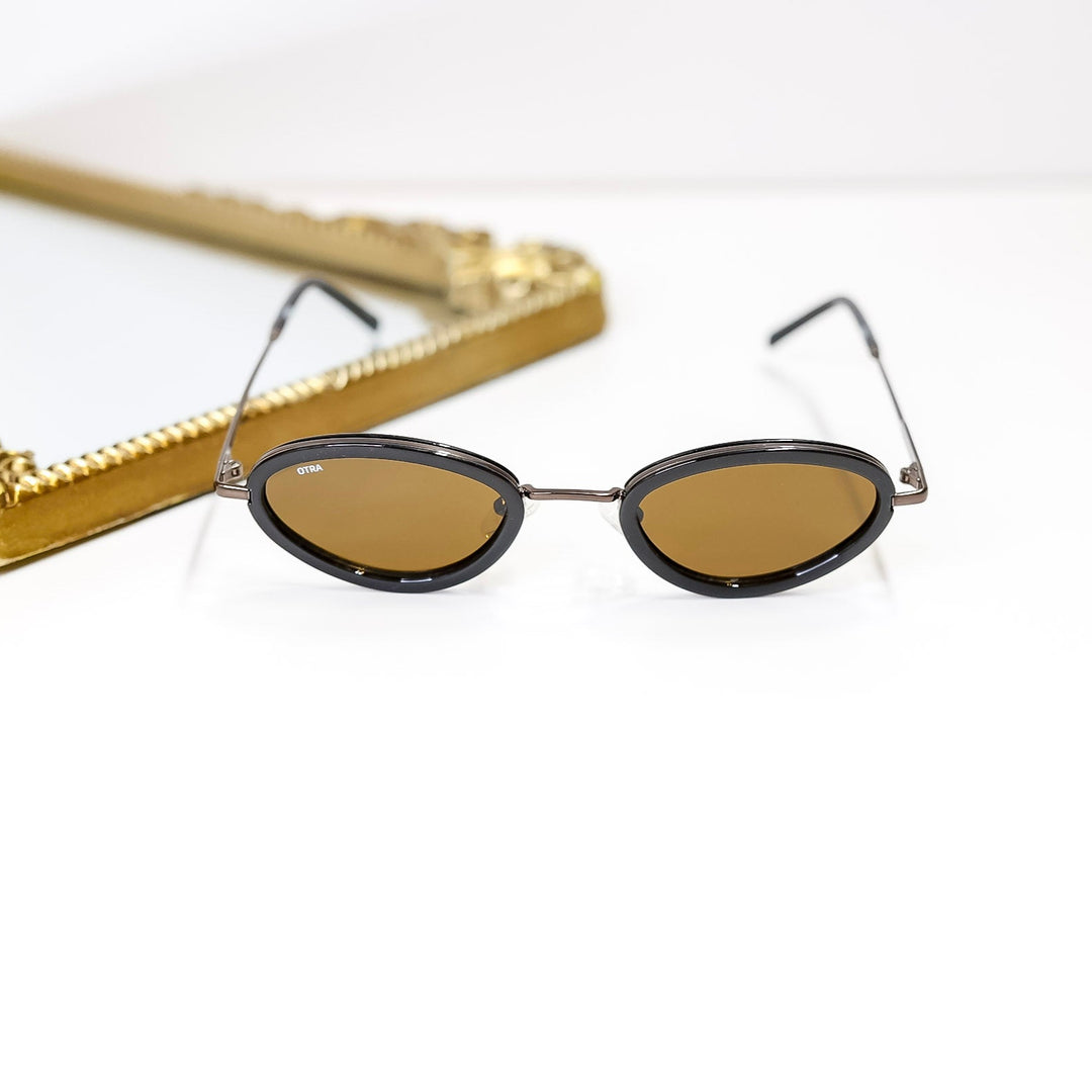 Small round sunglasses with gold frames on a white background
