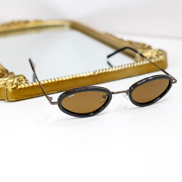 Sunglasses with a gold frame on a white background