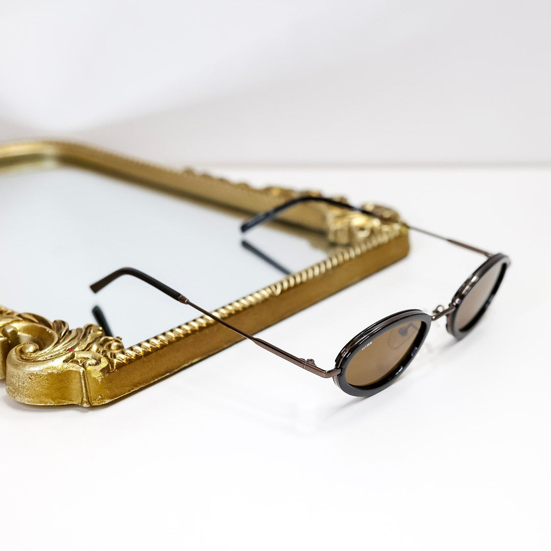 Gold-framed sunglasses on a white background