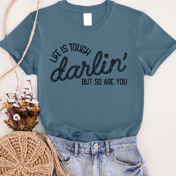 A short sleeve tee in slate blue and the phrase "light is tough darlin' but so are you" in black rope.