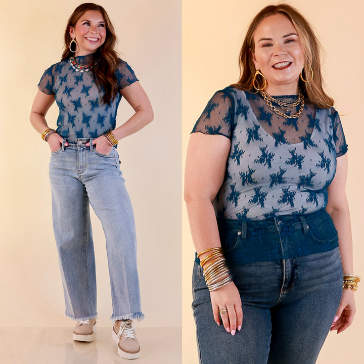 Models are wearing Sheer Mock Neck Short Sleeve Top in Teal Blue with Jeans  against a beige backdrop.