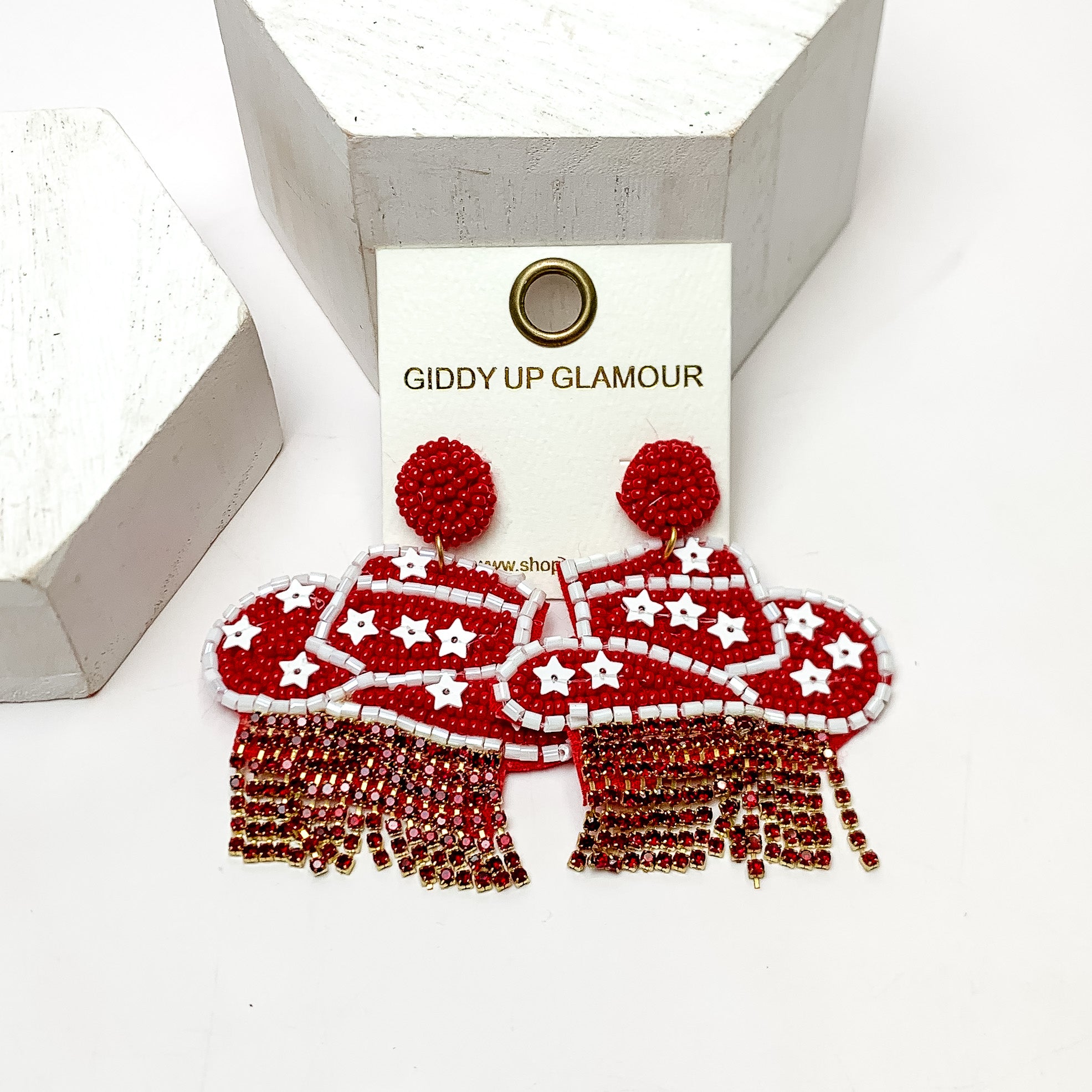 Gameday Beaded Cowboy Hat Earrings with White Crystal Fringe in Maroon and White. These earrings are pictured on a white background with white posts behind them.