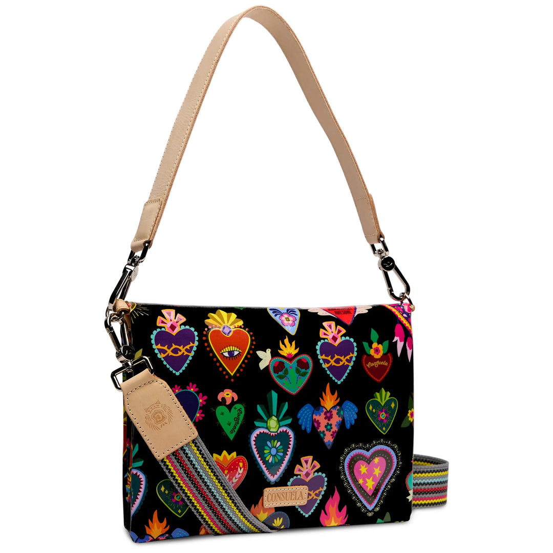 A black shoulder bag with a colorful pattern of embroidered-style hearts and floral motifs, featuring a beige leather strap and a striped detachable crossbody strap, shown on a white background.