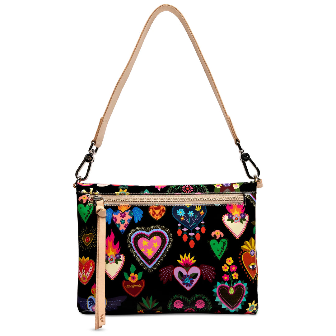 A black shoulder bag with a colorful embroidered pattern of hearts and floral motifs, featuring a tan leather strap and zipper pull.