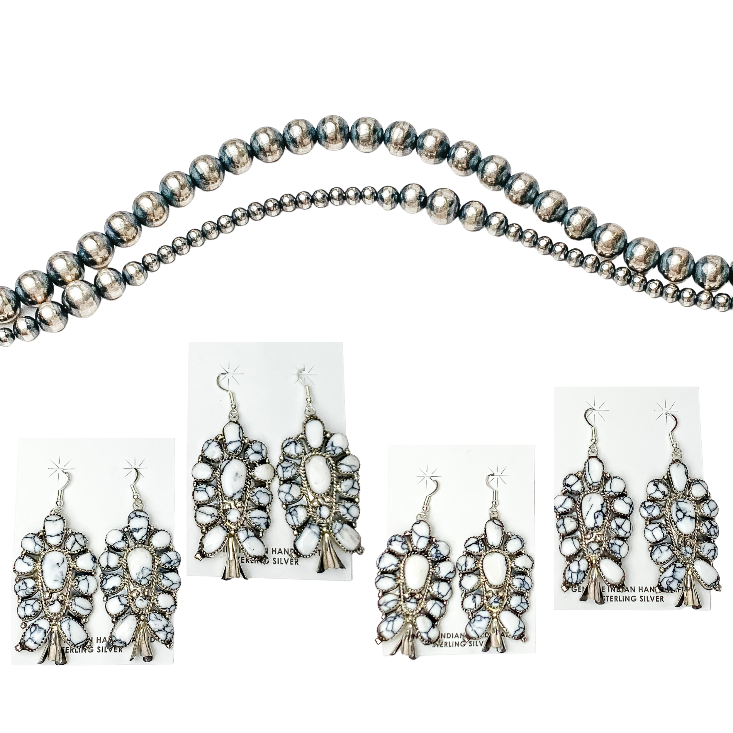Centered in the picture is 4 sets of white buffalo cluster squash blossom earrings. Navajo pearls are laid above the earrings, all on a white background. 