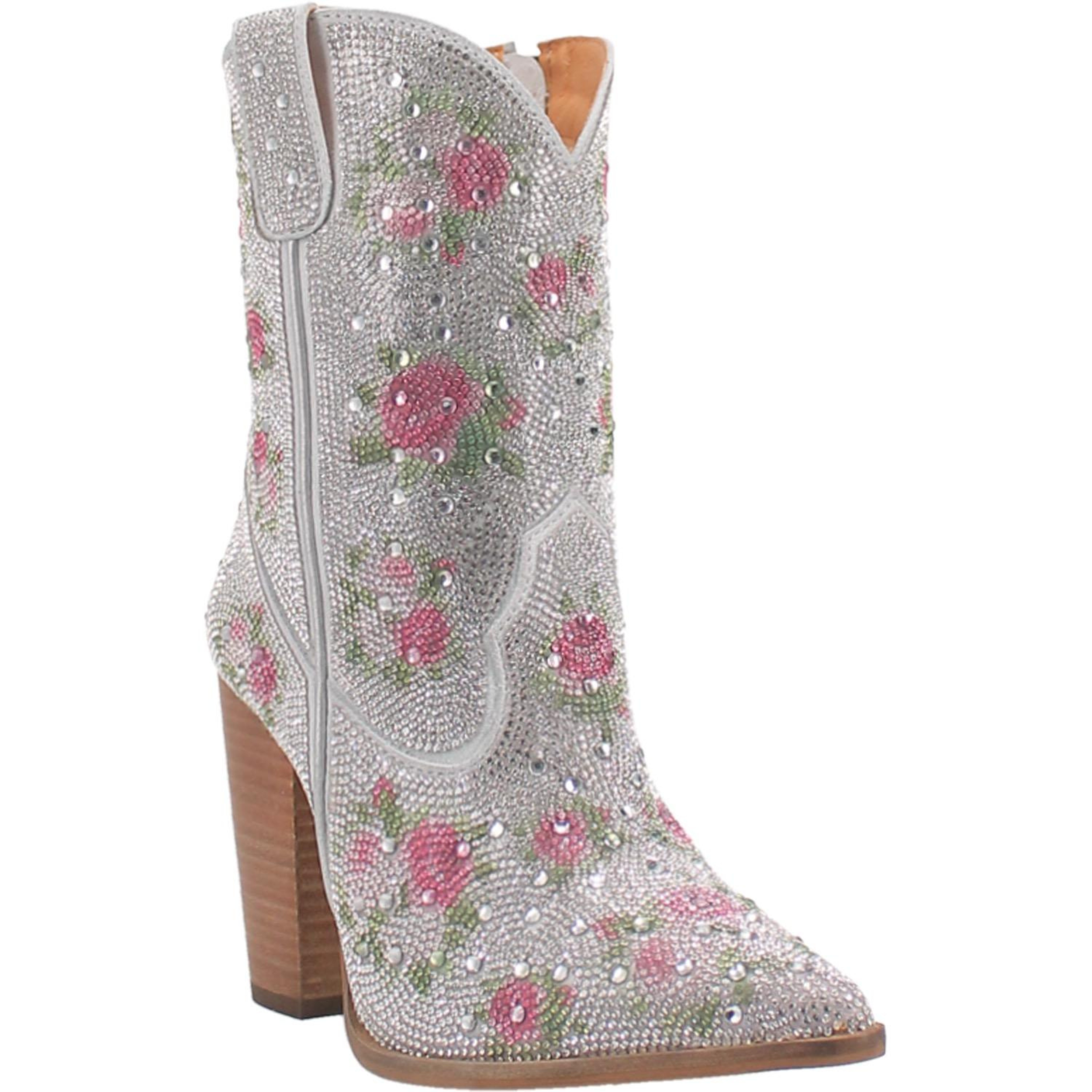 A small boot with a tall heel, rhinestones from top to bottom, pink rhinestone flowers with green rhinestone leaves, bedazzled straps, and V cut at the top. Item is pictured on a plain white background