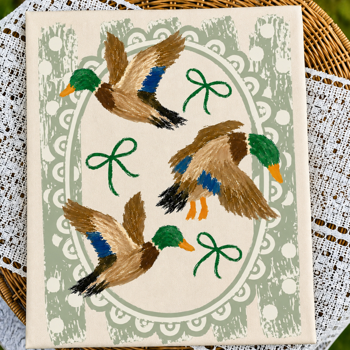 Ivory or brown graphic tee or sweatshirt featuring three painted mallard ducks, green bows, sage polka dots and a scalloped oval frame.