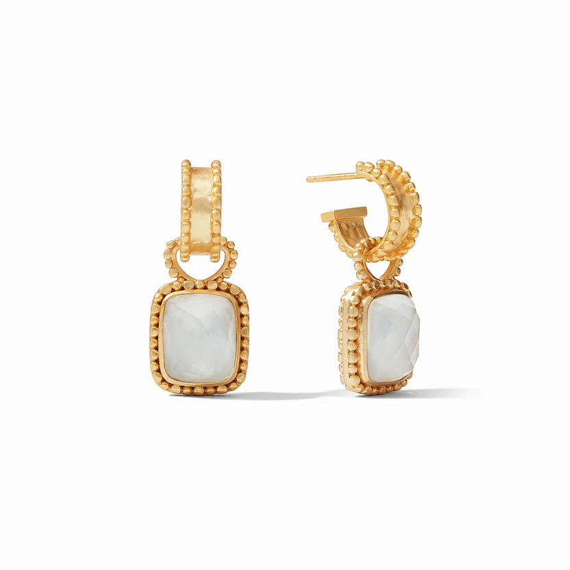 Pictured is a pair of gold hoop earrings with a square charm. The charm is a clear iriescent charm with a gold outline. These earrings are pictured on a white background. 