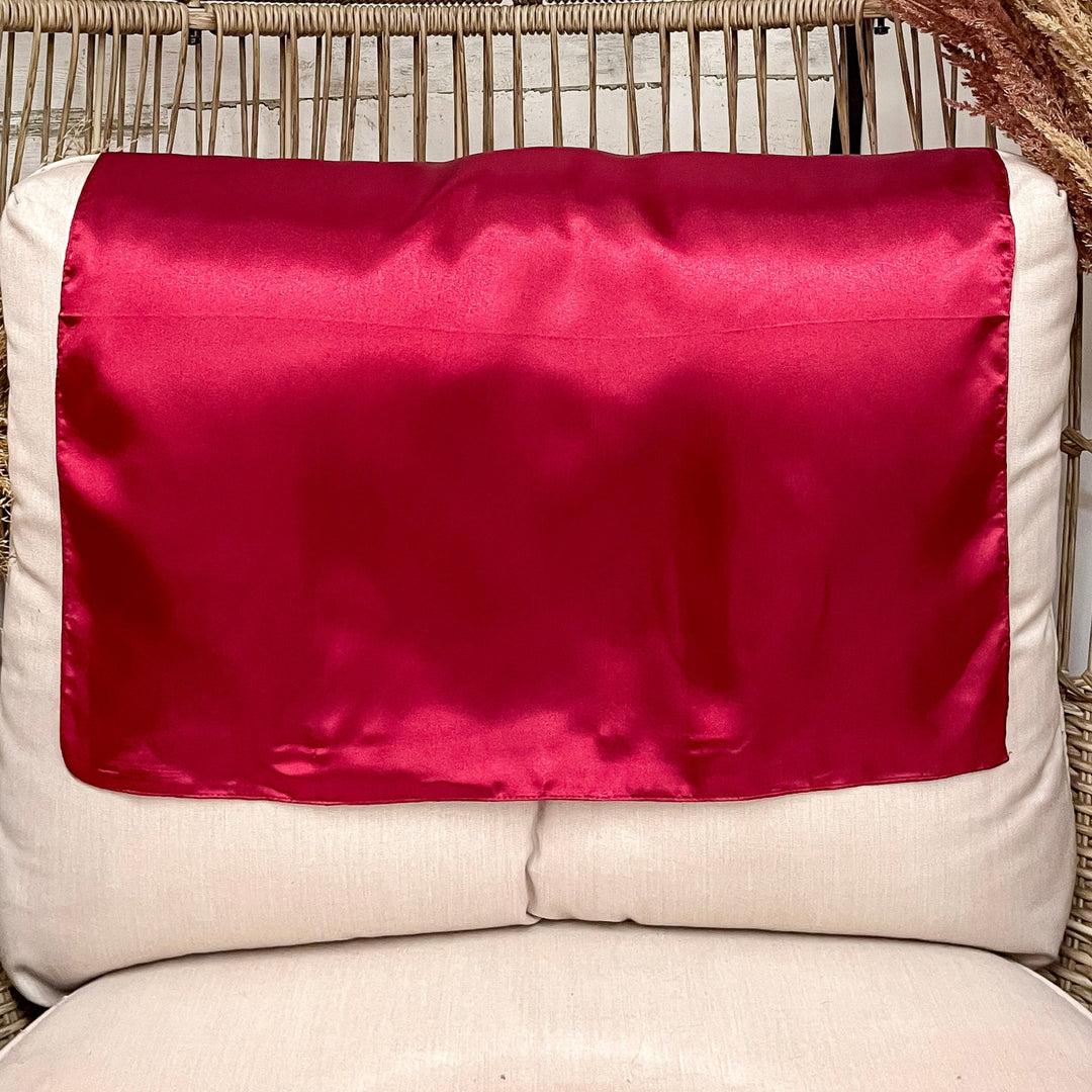 A rustic chair with a red solid mini wild rag open