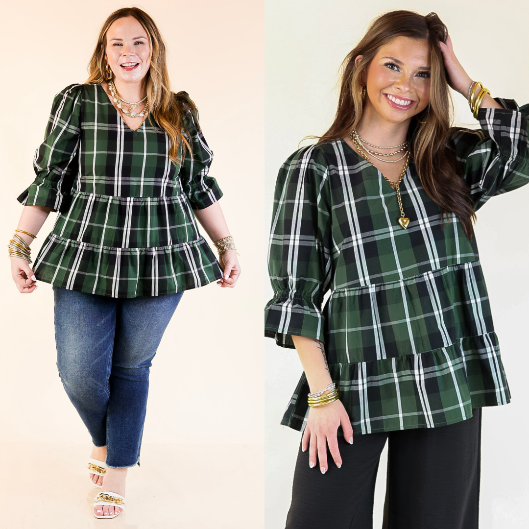 Two women wearing green plaid tops with ruffles and balloon sleeves on a plain background