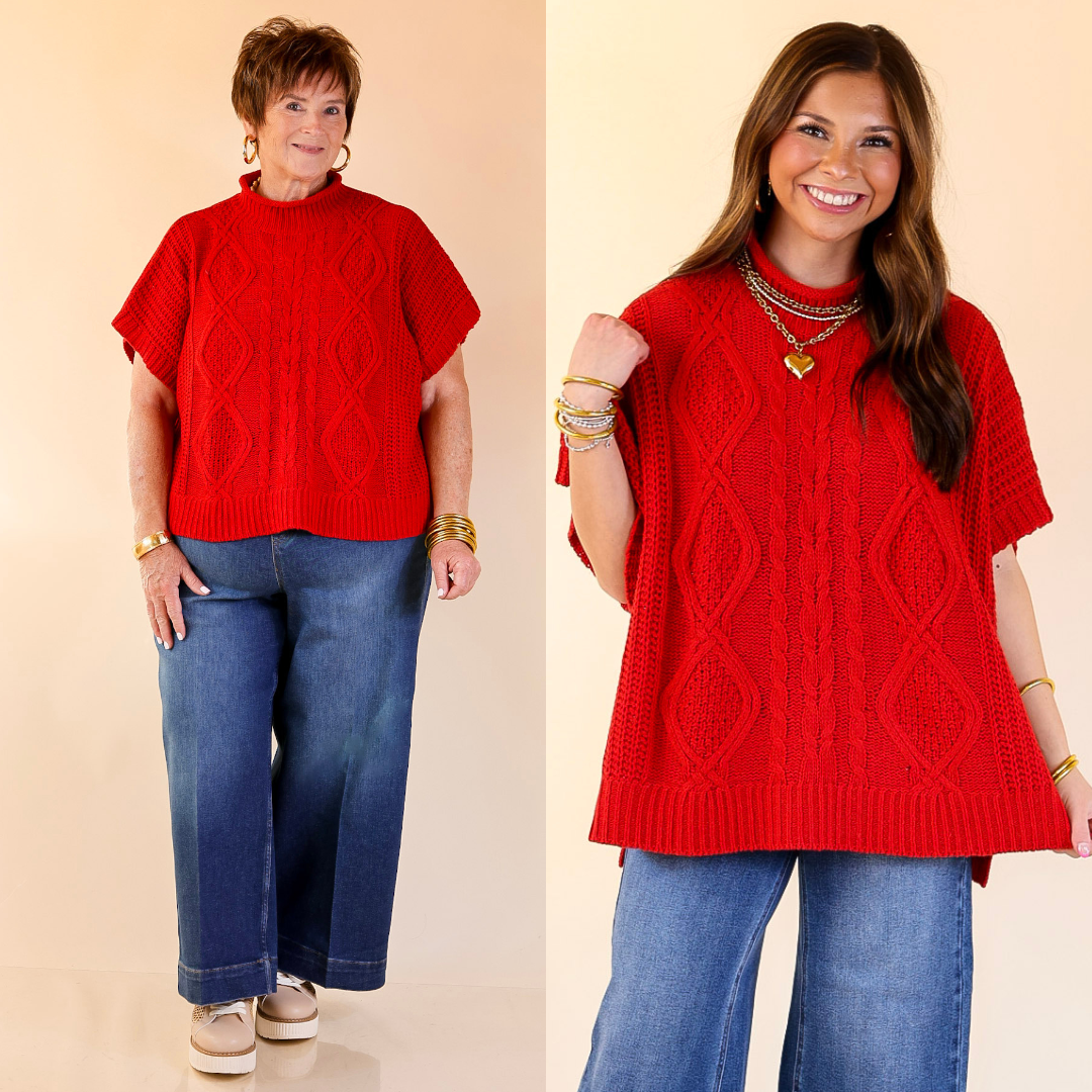 Two women wearing red sweater poncho tops and blue jeans on a beige background