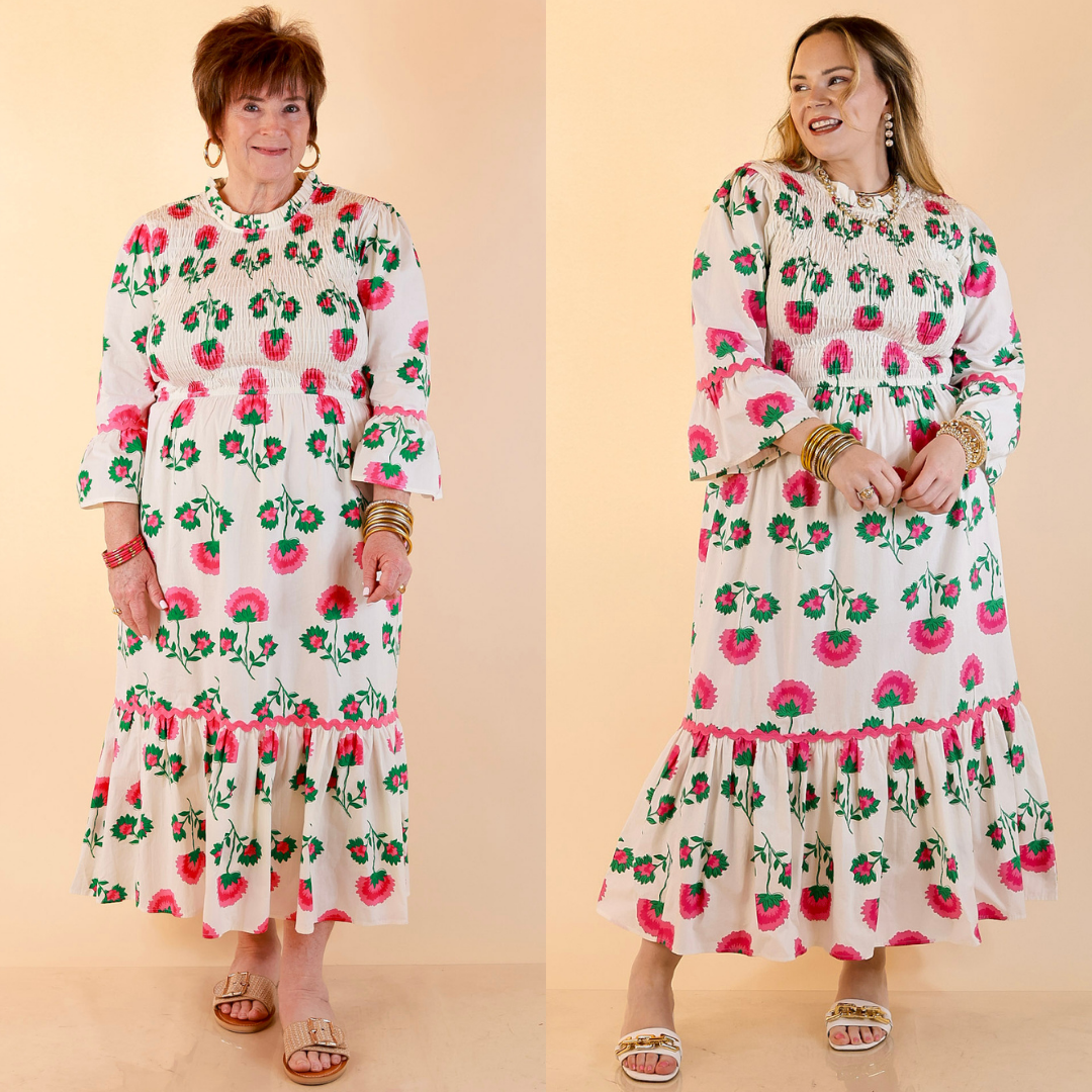 Models are wearing Smocked Floral Print Tiered Midi Dress with Scallop Trim in Cream Multi against a beige backdrop. 