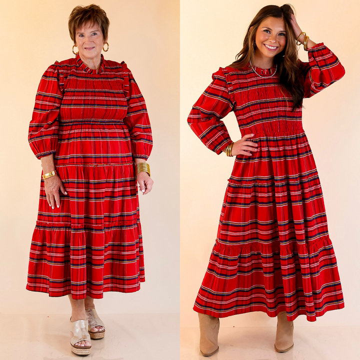 Two women wearing red plaid dresses with long sleeves against a beige background