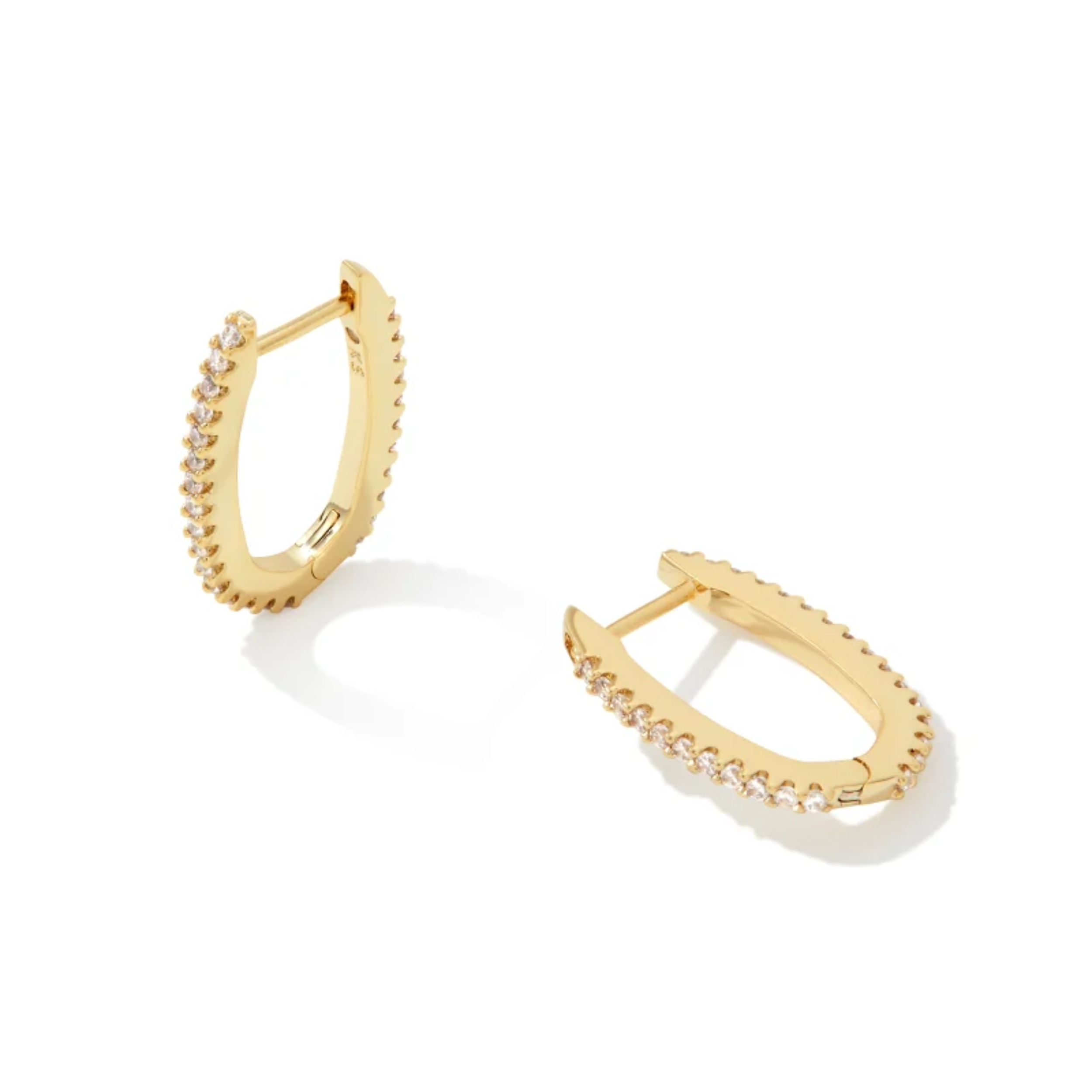 These Murphy Pave Gold Huggie earrings in White Crystal by Kendra Scott ae pictured on a white background.