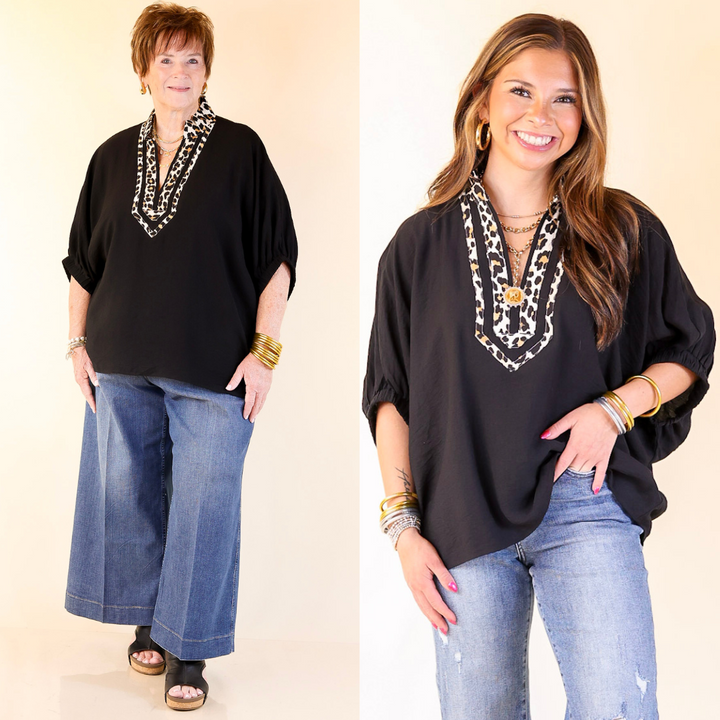 Two women wearing black tops with Leopard necklines with jeans on a beige background.