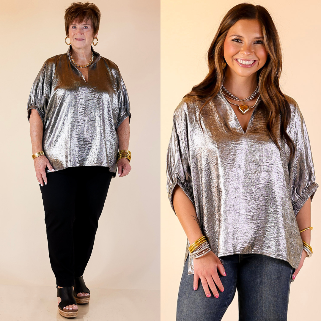Two women wearing silver metallic tops with jeans against a beige background