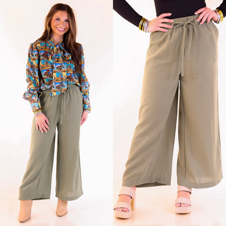 Woman wearing olive green cropped woven pants on a white background