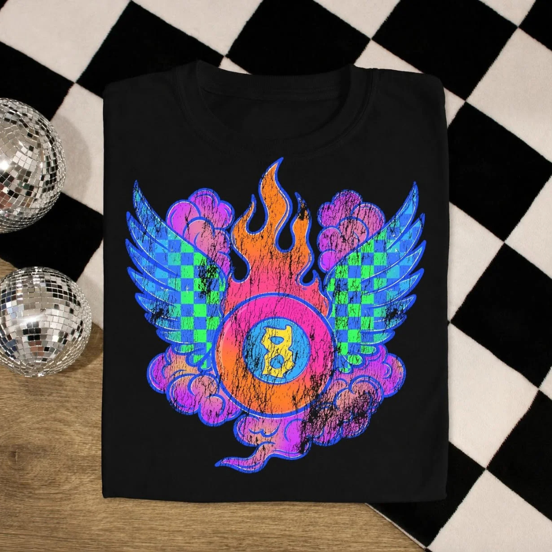 Black graphic tee featuring a colorful lucky number design with checkerboard wings, clouds, and flame accents.