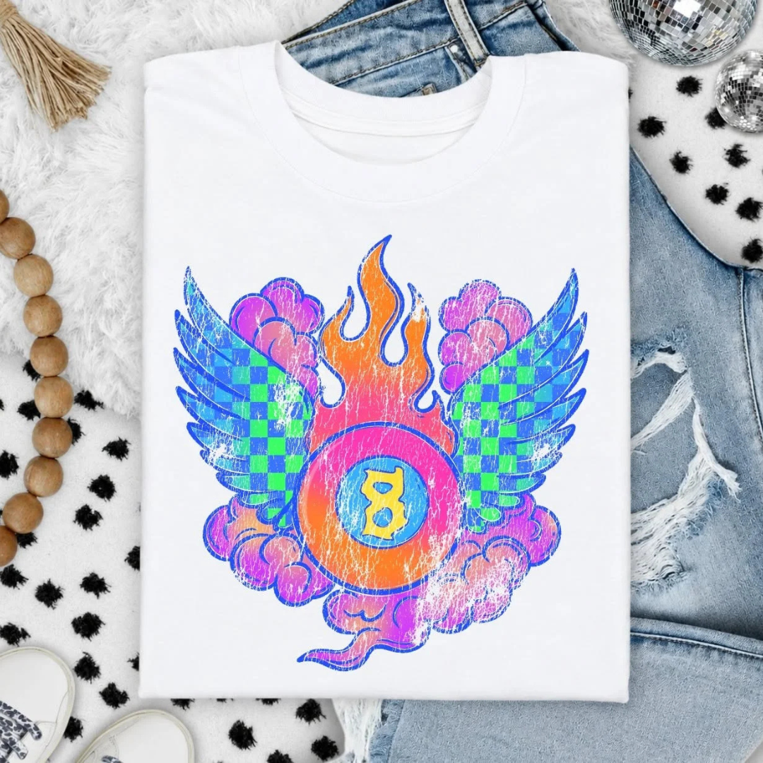 White graphic tee featuring a colorful distressed winged B graphic with checkerboard wings, flames, and vibrant retro-inspired details.
