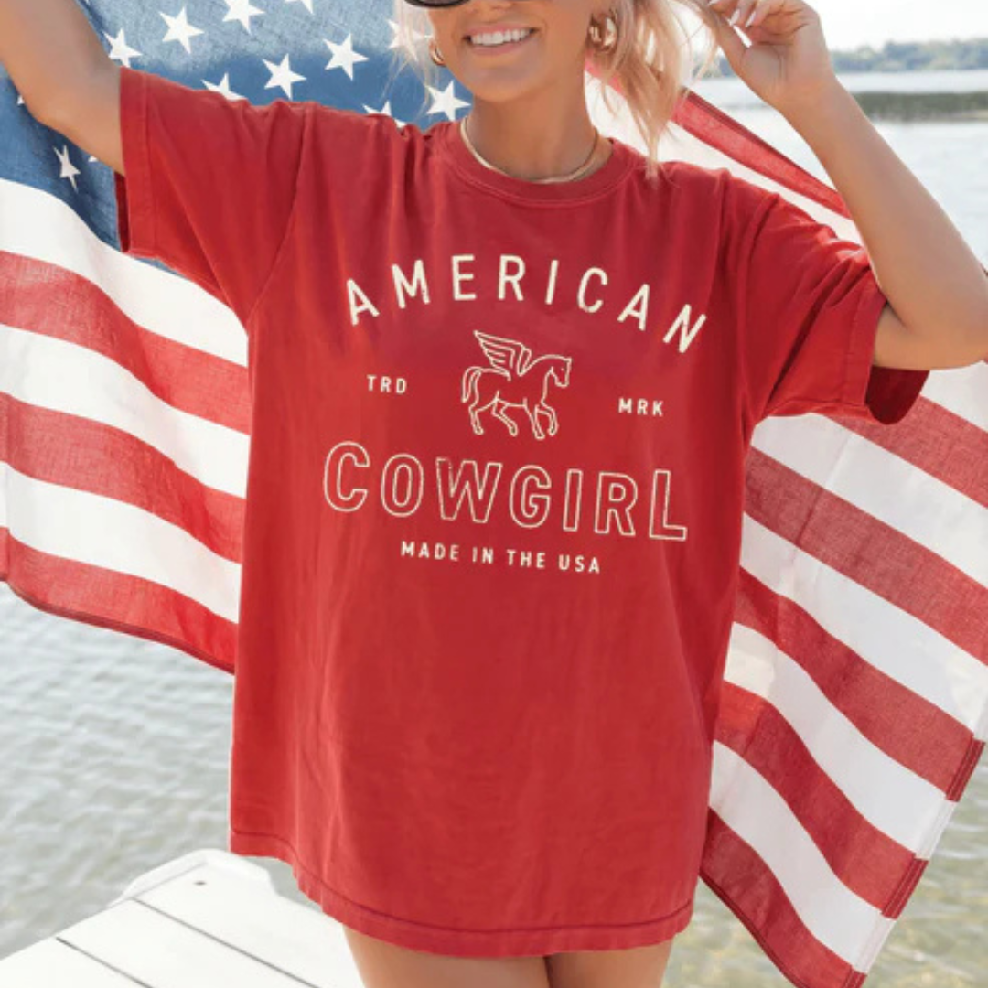 Red Comfort Colors graphic t-shirt featuring American Cowgirl lettering with a vintage western horse emblem.