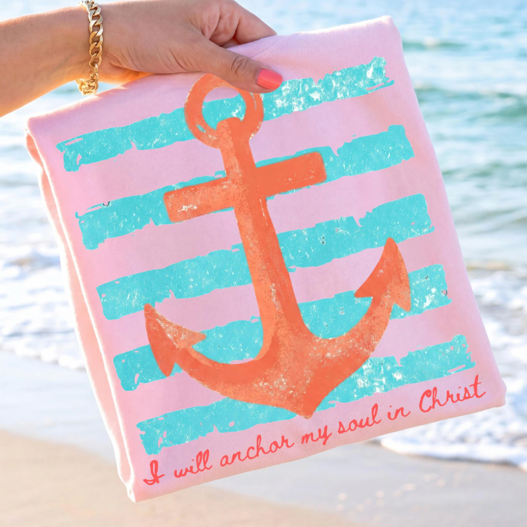 Light pink graphic tee featuring a coral anchor, turquoise stripes, and the phrase "I will anchor my soul in Christ."