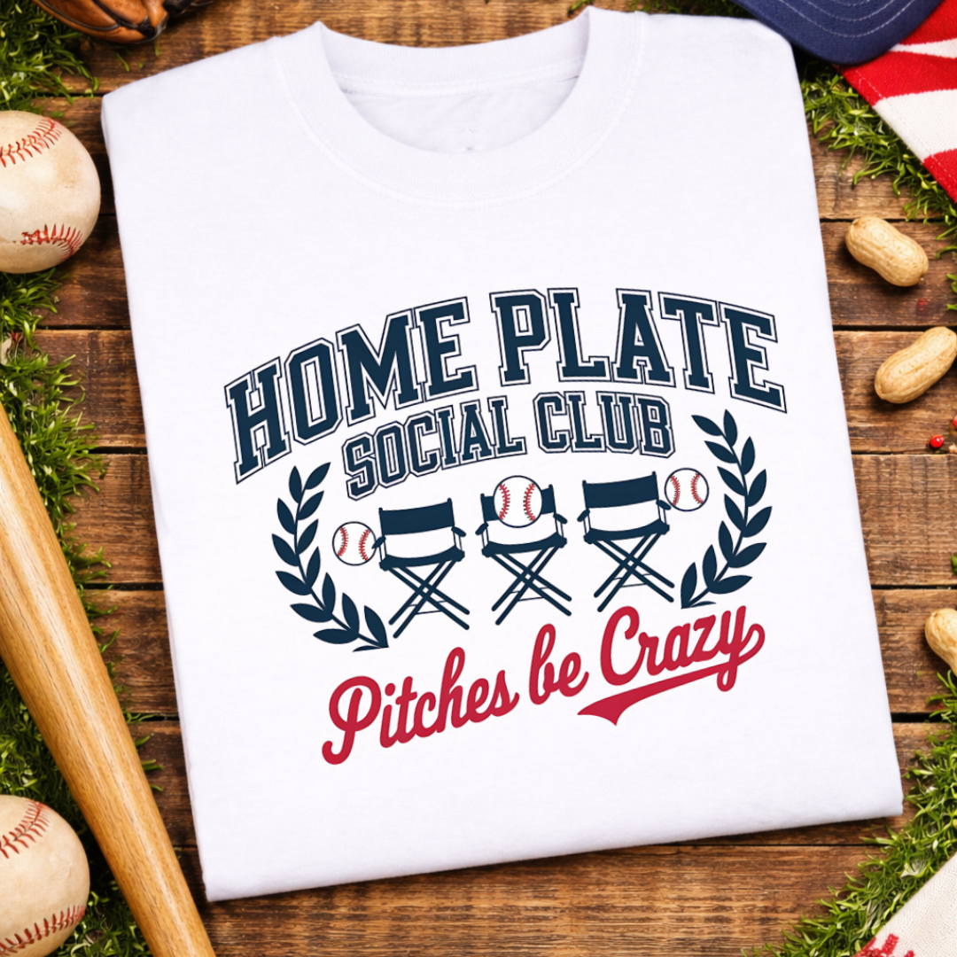 White graphic tee featuring "Home Plate Social Club" with stadium chairs, baseball accents, and the phrase "Pitches Be Crazy."