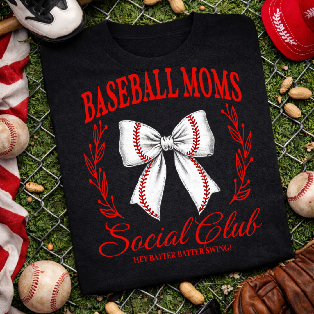 Black graphic tee featuring "Baseball Moms Social Club" with a baseball stitch bow, red botanical accents, and the phrase "Hey Batter Batter Swing!"
