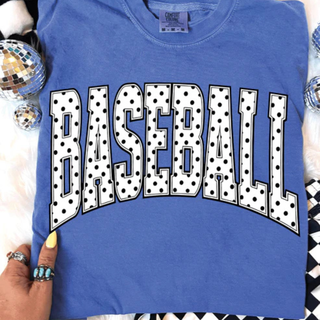 Comfort Colors graphic t-shirt featuring a bold BASEBALL design with classic black and white polka dot lettering.