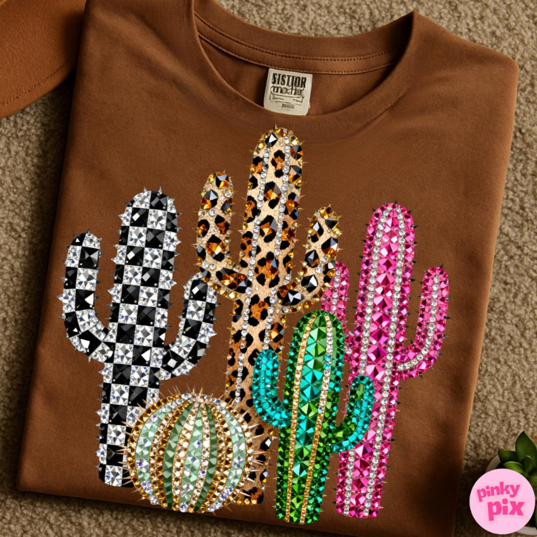 Saddle brown graphic tee featuring colorful cactus designs with checkered, leopard, pink, and crystal-inspired details.