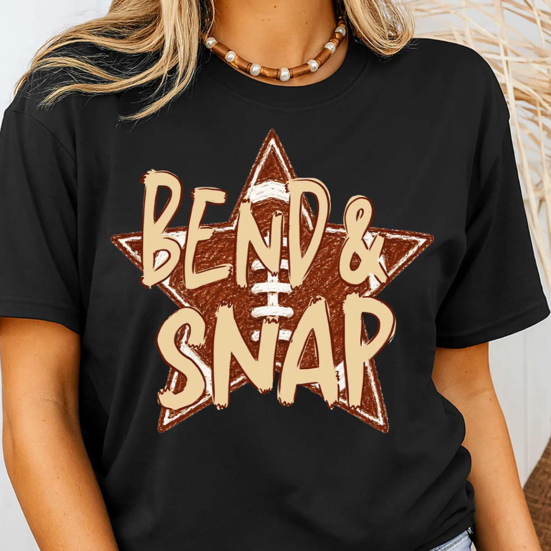 Black graphic tee featuring a distressed football star with bold "Bend &amp; Snap" lettering in tan and brown for football season.