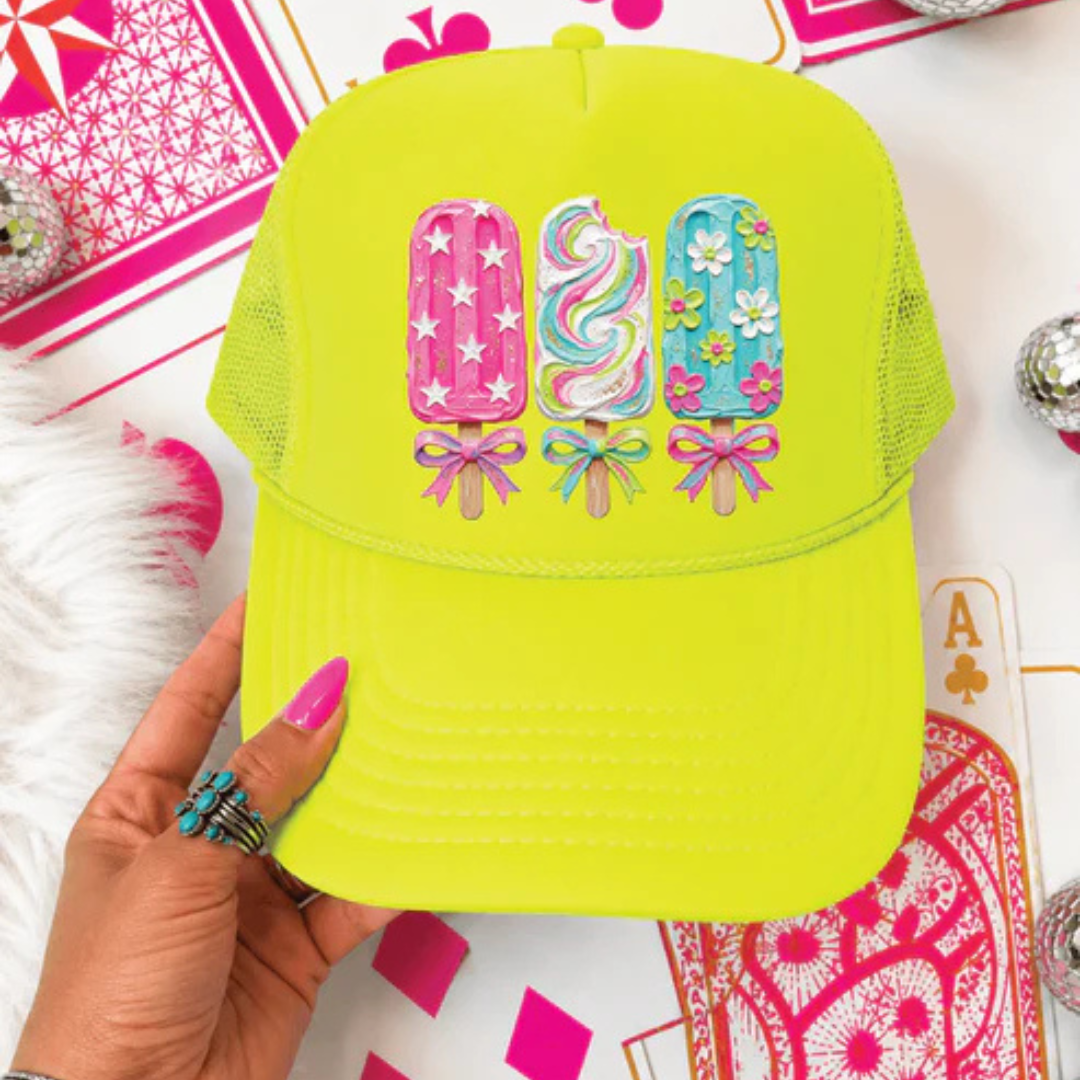 Neon yellow foam trucker hat featuring three colorful decorative popsicles with floral, star, swirl, and bow accents.