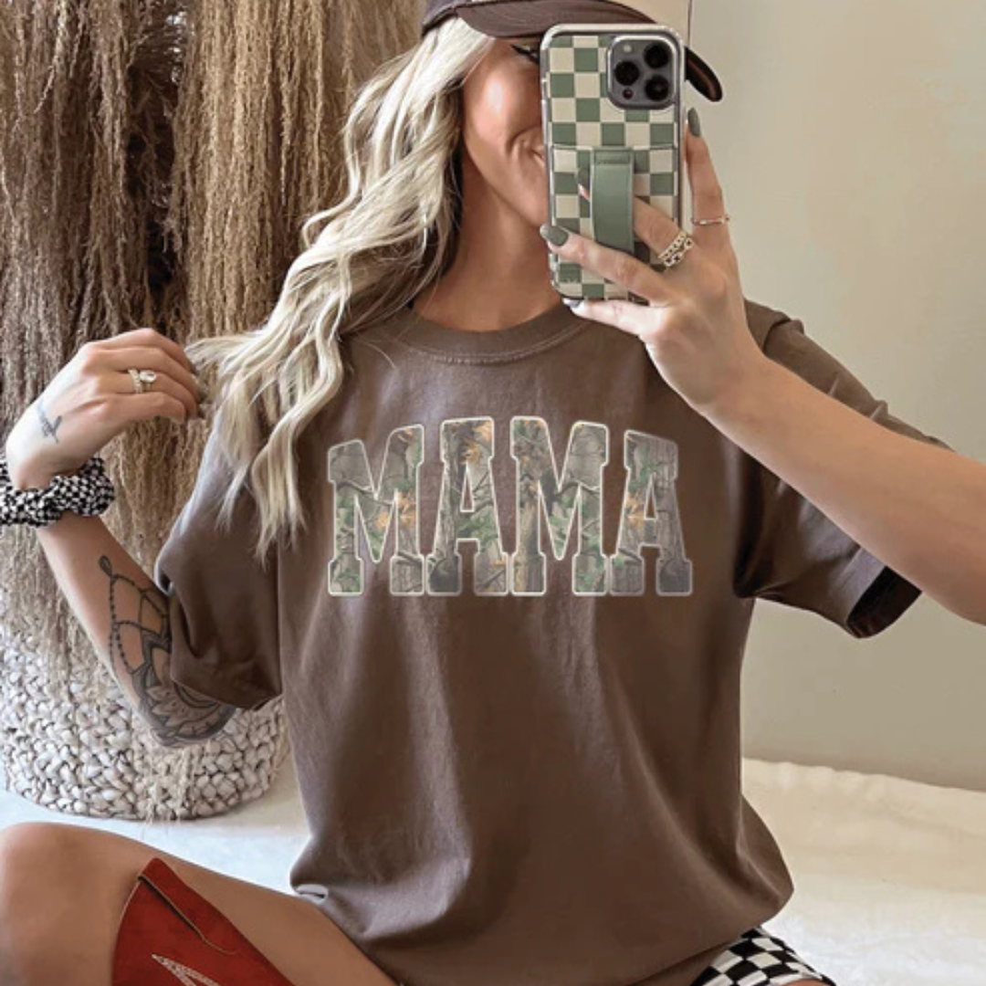 Graphic tee and sweatshirt featuring a bold varsity-style MAMA design with camouflage print lettering.