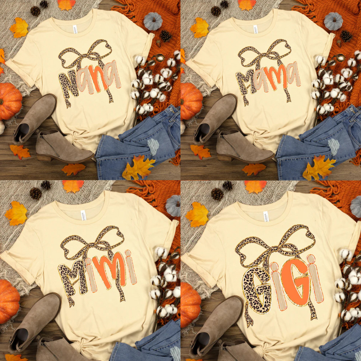 Collage of four cream-colored t-shirts with 'NANA' 'MAMA', 'MIMI', and 'GIGI' text and decorative elements on a fall-themed background.