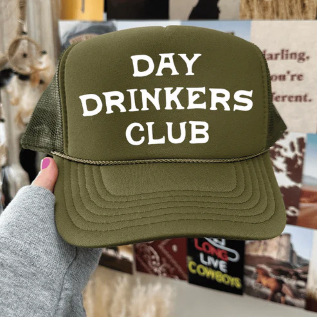 Foam trucker hat featuring "Day Drinkers Club" in bold retro white lettering on the front panel.