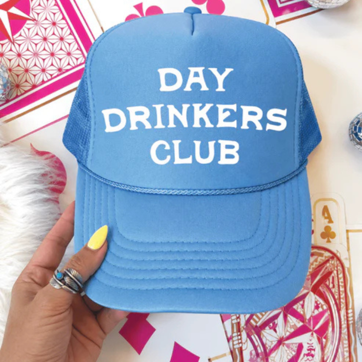 Foam trucker hat featuring "Day Drinkers Club" in bold retro white lettering on the front panel.