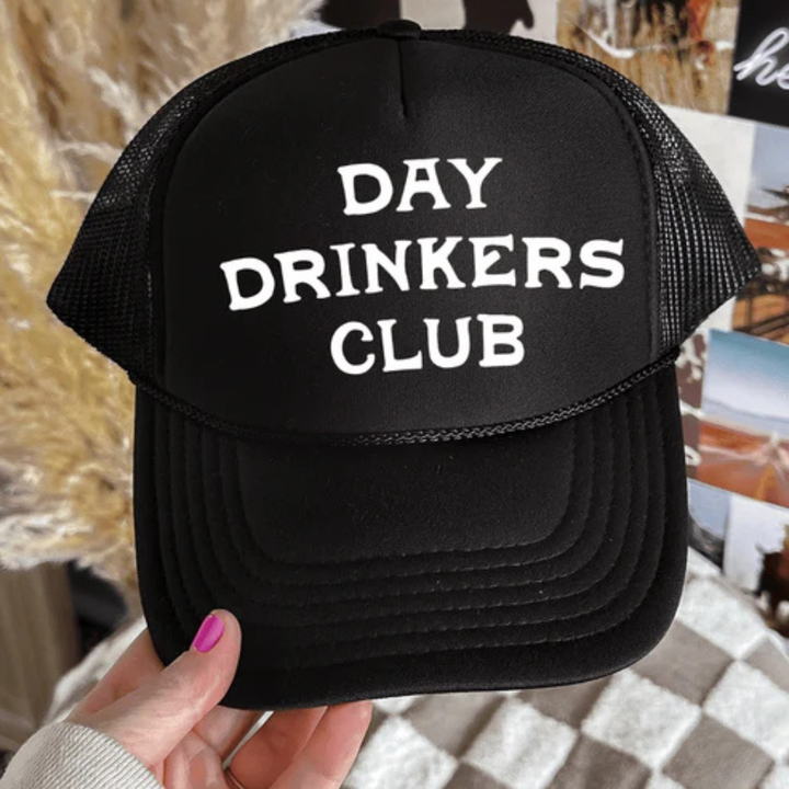 Foam trucker hat featuring "Day Drinkers Club" in bold retro white lettering on the front panel.