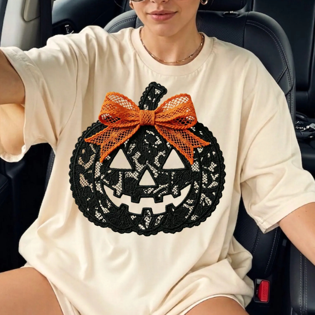 Cream graphic tee featuring a black faux lace jack-o&