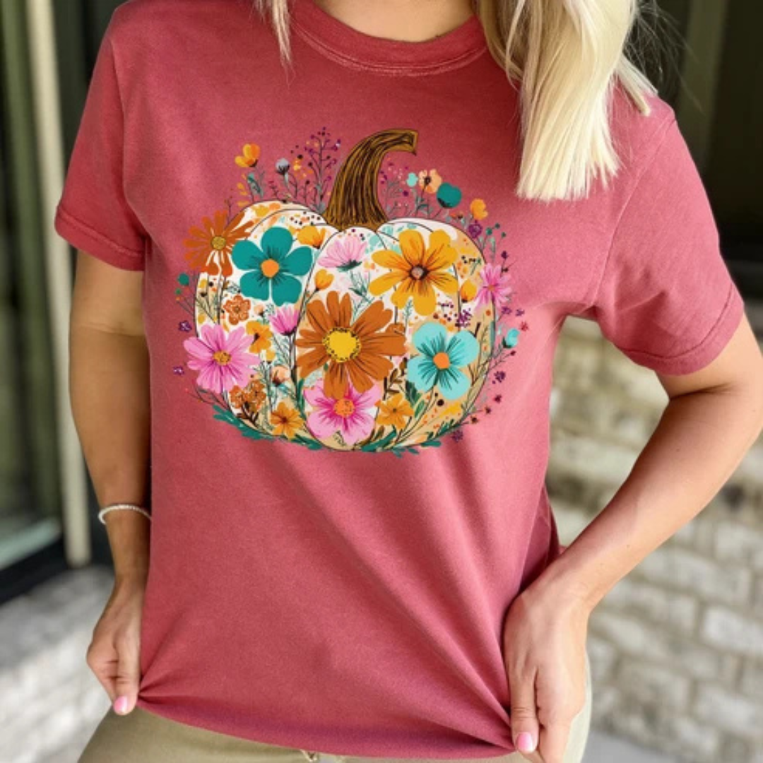 Berry rose graphic tee featuring a pumpkin filled with colorful wildflowers in teal, pink, orange, cream, and yellow.