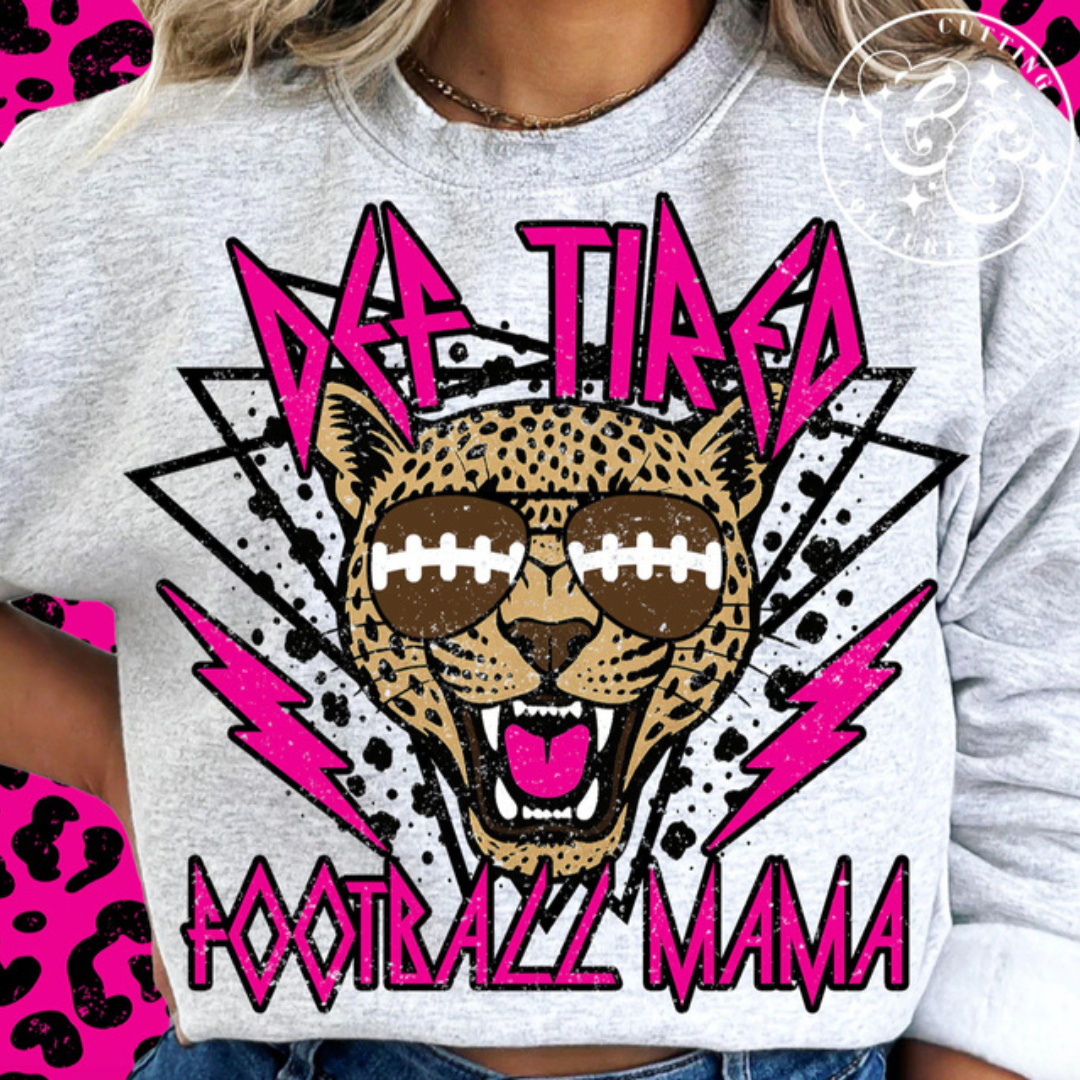 Ash grey graphic tee featuring a fierce leopard wearing football sunglasses with hot pink lightning bolts and bold Football Mama lettering.