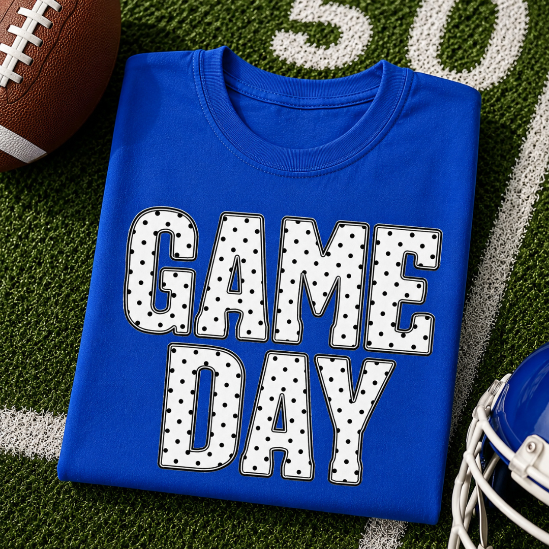 Royal blue graphic tee featuring bold white "GAME DAY" lettering with black polka dots.