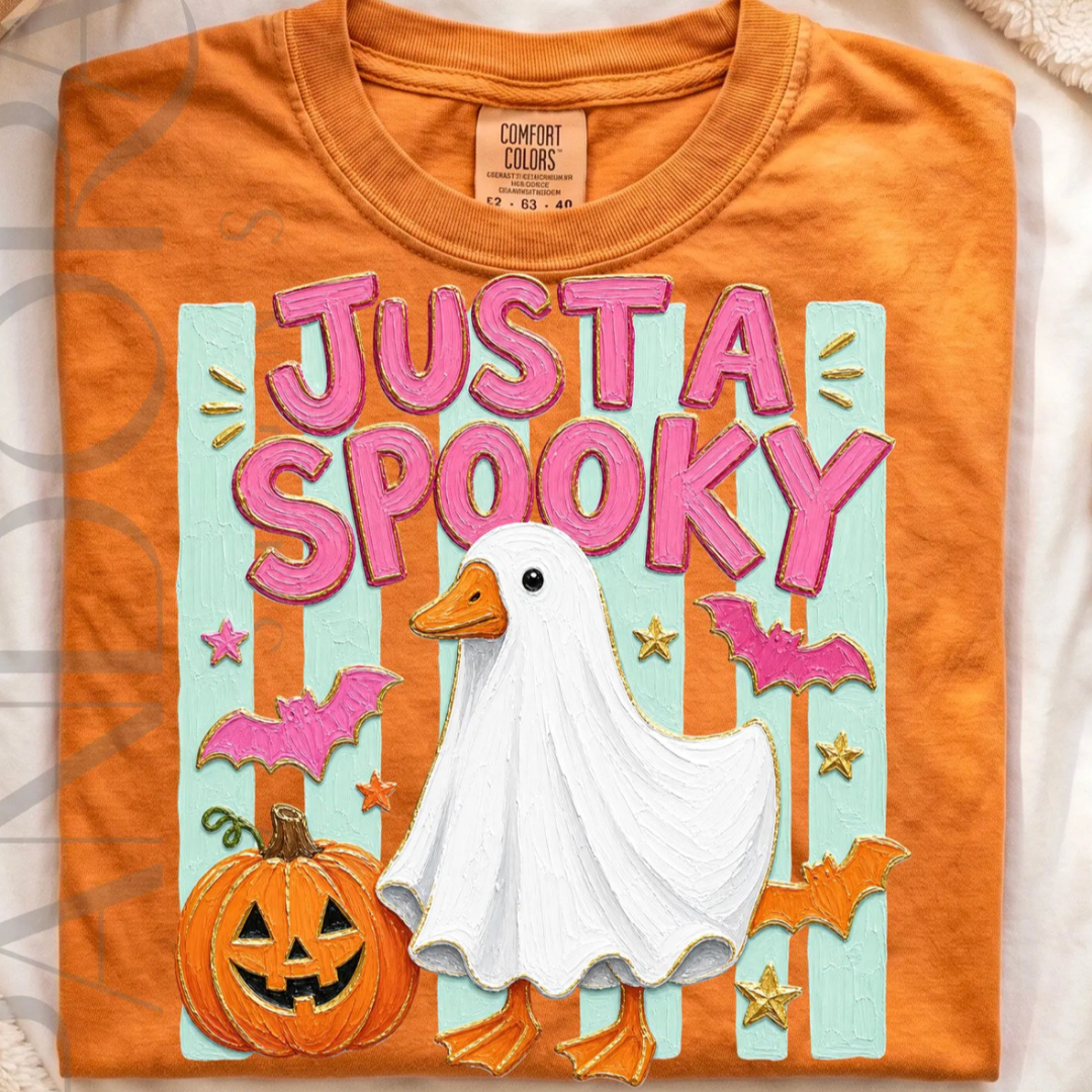 Burnt orange Comfort Colors graphic tee featuring a goose dressed as a ghost with "Just a Spooky" lettering, pumpkins, bats, stars, and colorful Halloween artwork.