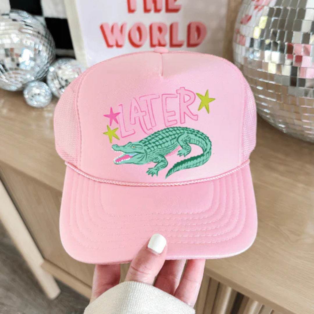 Light pink foam trucker hat featuring a Later Gator graphic with a hand-drawn alligator and colorful retro-inspired accents.