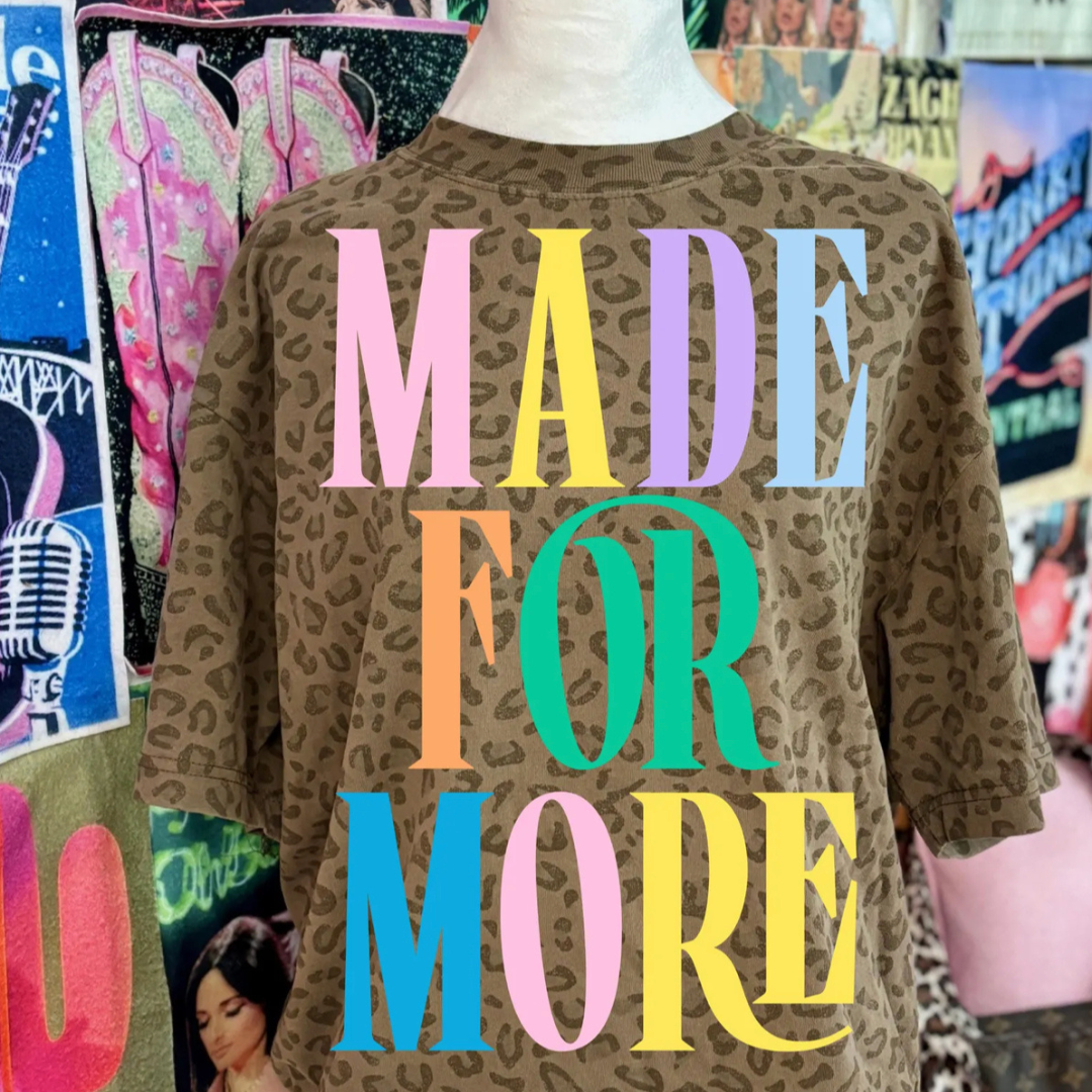 Mocha brown leopard print graphic tee featuring colorful pastel "Made for More" lettering across the front.