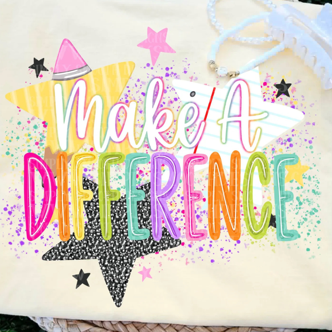 Butter yellow teacher graphic tee featuring colorful "Make a Difference" lettering with stars, notebook paper, and paint splatter accents.