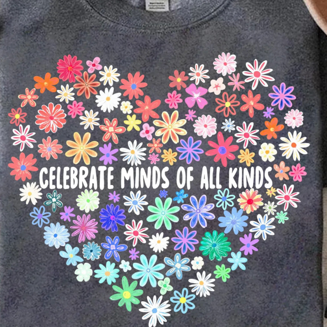 Charcoal gray teacher graphic tee featuring a colorful floral heart surrounding the phrase "Celebrate Minds of All Kinds."