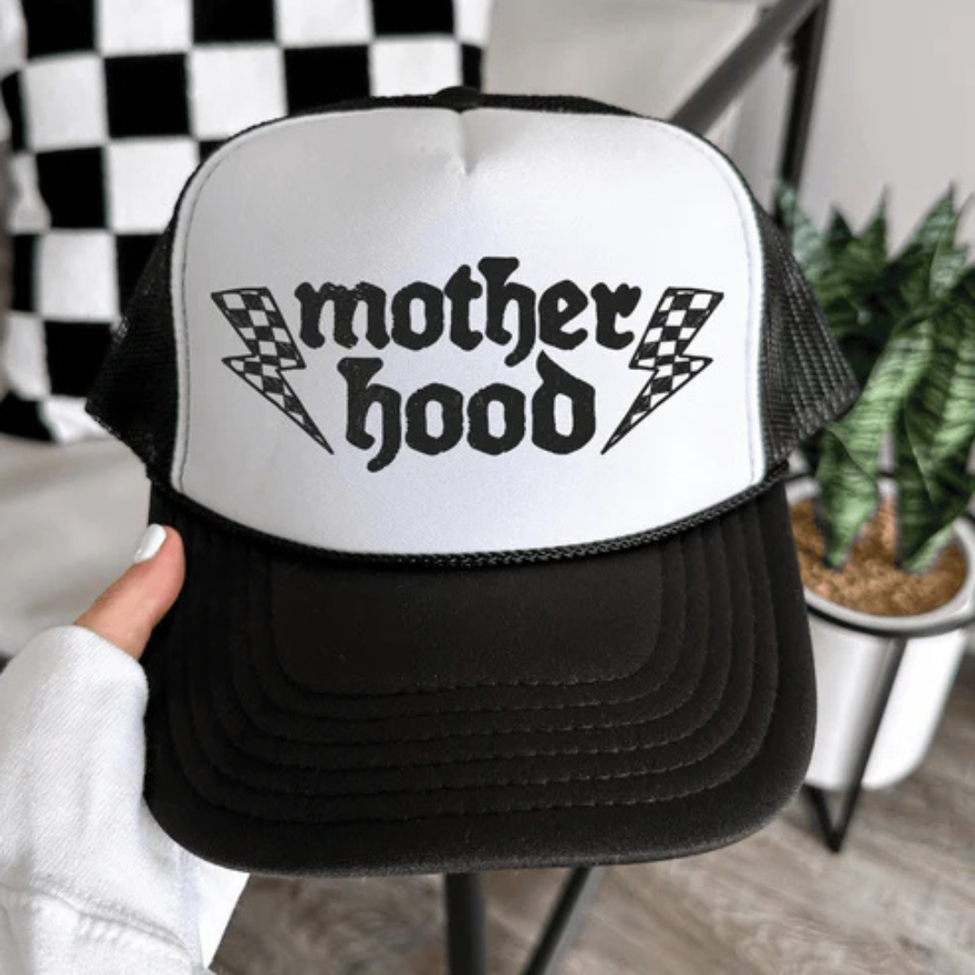 Black and white foam trucker hat featuring a bold Motherhood graphic with lightning bolt accents.