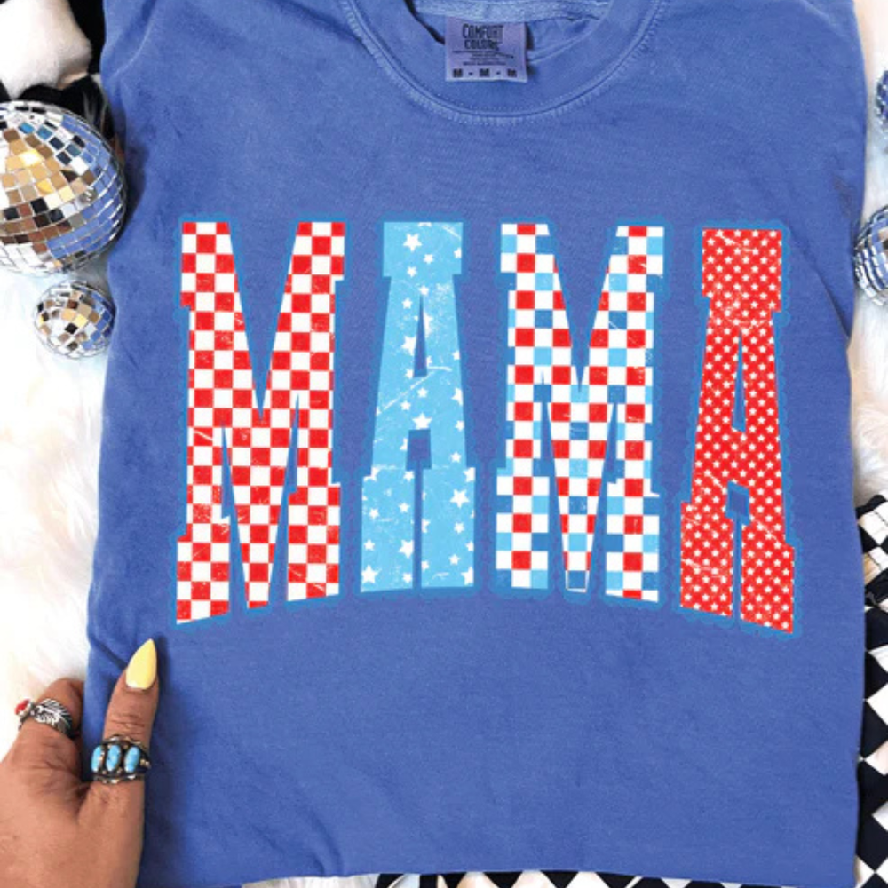 Comfort Colors graphic t-shirt featuring patriotic MAMA lettering with red, white, and blue patterns on multiple shirt color options.