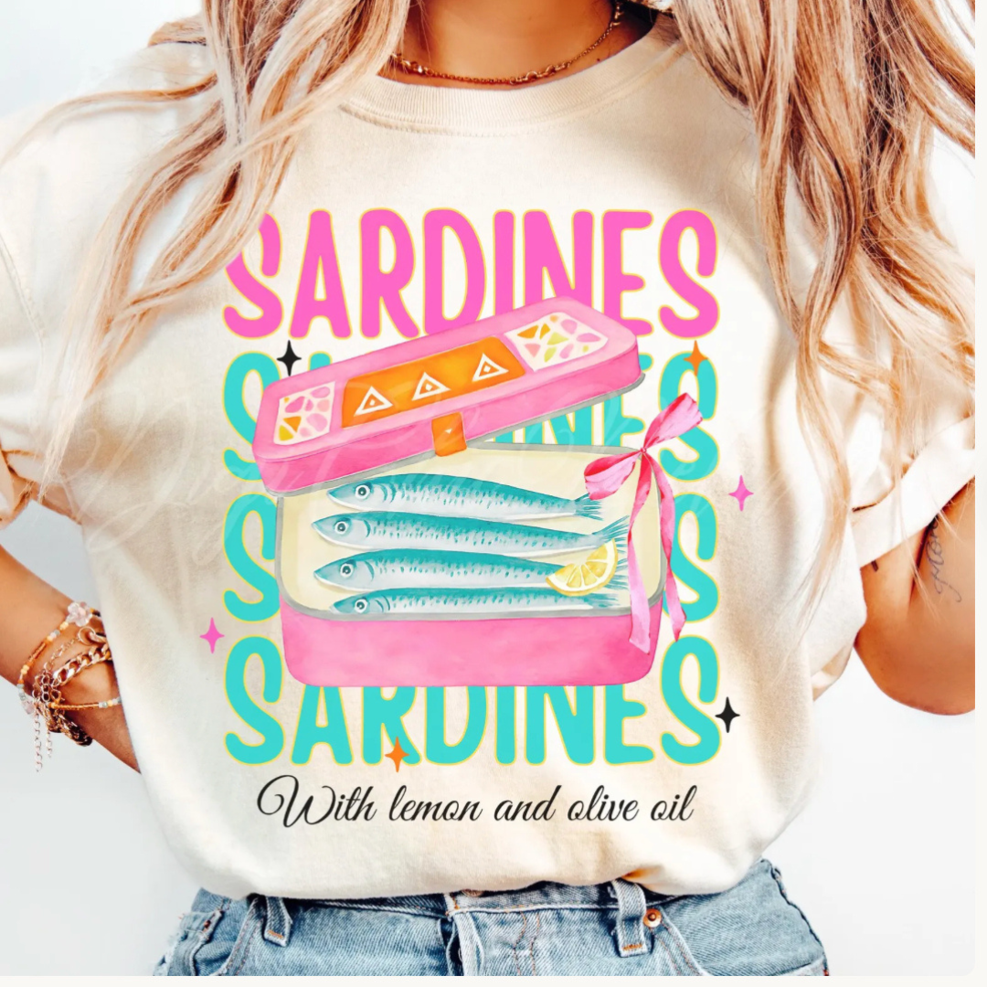 Natural graphic tee featuring a colorful vintage sardine tin with lemon and olive oil design and retro coastal typography.