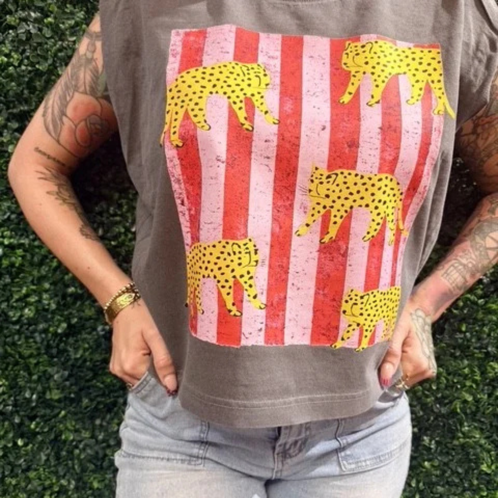 Vintage taupe sleeveless graphic tee featuring a distressed patriotic striped design with yellow leopard silhouettes.